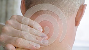 Close up man doing massage his neck to relieve fatigue and relaxation