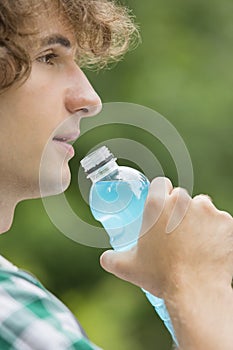 Close-up of man drinking energy drink outdoors