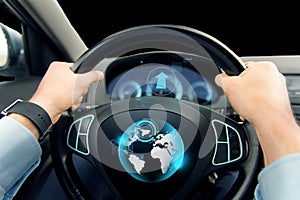 Close up of man driving car with globe on screen