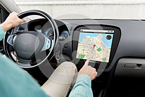 Close up of man driving car with gps navigator map