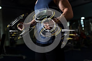 Close up of man with dumbbells exercising in gym