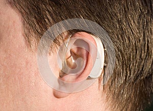 Close-up of a man ear with a hearing aid