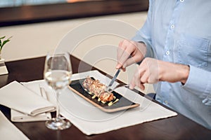 Close up of a man eating seafood at the restaurant