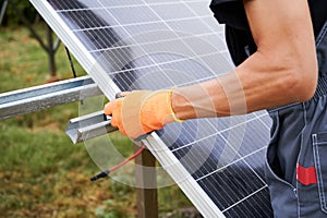 Close up of man engineer installing solar modules
