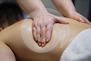 Close-up of man enjoying in relaxing back massage . Man relaxing on massage table receiving massage