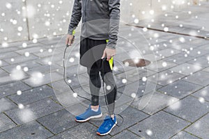 Close up of man exercising with jump-rope outdoors