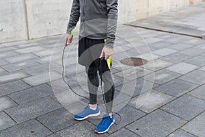 Close up of man exercising with jump-rope outdoors