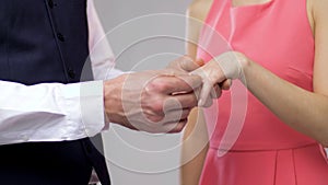 Close up of man giving diamond ring to woman