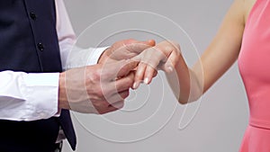 Close up of man giving diamond ring to woman