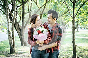 Close-up of a man giving happy woman flowers.A picture of a romantic couple