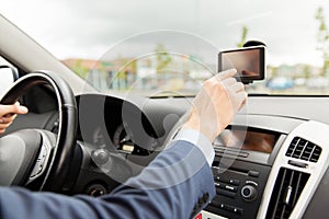 Close up of man with gps navigator driving car