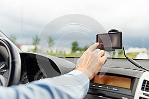 Close up of man with gps navigator driving car