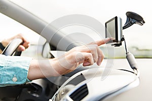 Close up of man with gps navigator driving car