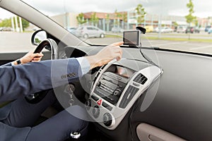 Close up of man with gps navigator driving car