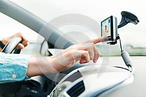 Close up of man with gps navigator driving car