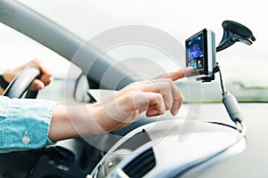 Close up of man with gps navigator driving car