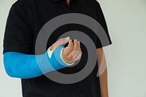 Close up man hand with blue bandage as arm injury concept