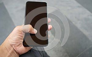 Close up of man hand holding smart phone with blank screen, lifestyle concepts