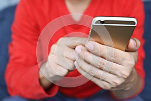 Close up of a man hand holding using mobile smart phone outdoor cell phone