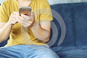 Close up of a man hand holding using mobile smart phone outdoor cell phone