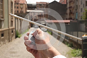 Close up on man hand opening a gate with a remote control