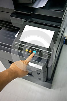 Close-up man Hand press button on panel of printer, printer scanner laser office copy machine