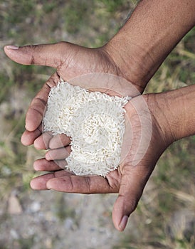 Close up man hand with rice in love shape