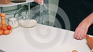 Close up of man hand sieving flour