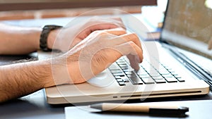 Close up of man hand typing keyboard laptop computer, work from home, study at home, people and online technology, internet of