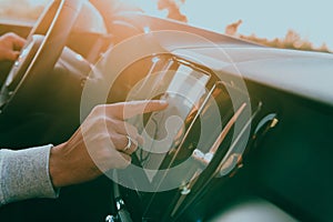 Close-up Of Man Hand Using GPS Navigation Inside Car
