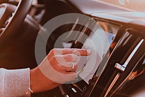 Close-up Of Man Hand Using GPS Navigation Inside Car
