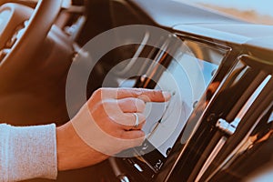 Close-up Of Man Hand Using GPS Navigation Inside Car