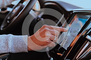 Close-up Of Man Hand Using GPS Navigation Inside Car