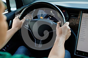 Close up of man hand on vehicle steering wheel as he is driving. Male driving a car in the highway, hands move on the