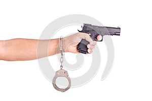 Close up man with handcuffs and gun on hands isolated on white