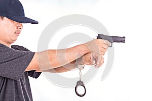 Close up man with handcuffs and gun on hands isolated on white