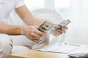 Close up of man hands counting money at home