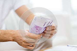 Close up of man hands counting money at home