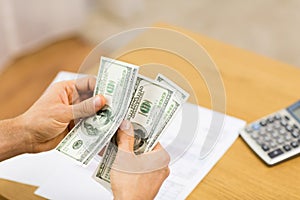 Close up of man hands counting money at home