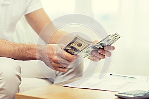 Close up of man hands counting money at home