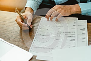 Close up man hands is filling out a job application form. Unemployed concept