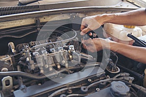Close up Man hands fixing Car machinery vehicle mechanical service. Mechanic man hands repairing car auto repair shop. open