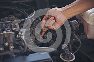 Close up Man hands fixing Car machinery vehicle mechanical service. Mechanic man hands repairing car auto repair shop. open