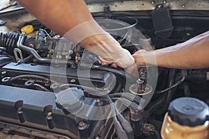 Close up Man hands fixing Car machinery vehicle mechanical service. Mechanic man hands repairing car auto repair shop. open