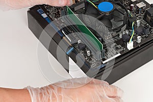 Close up of man hands with gloves installing Ram DDR4 memory mod