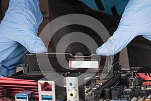 Close up of man hands with gloves installing Ram DDR4 memory mod