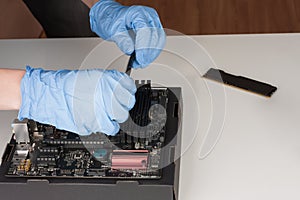 Close up of man hands with gloves installing Ram DDR4 memory mod