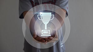 Close up man hands holding champion golden trophy  over background.