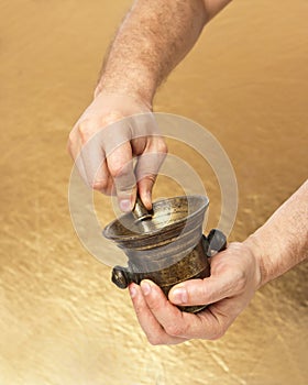 Close up of man hands with old mortar and pestle