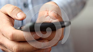 Close up of a man hands playing games on smart phone.